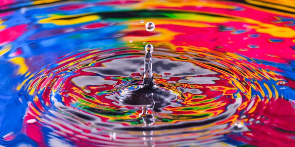 The impact of reputation is like ripples in a pond. Image of ripples in a rainbow pond.