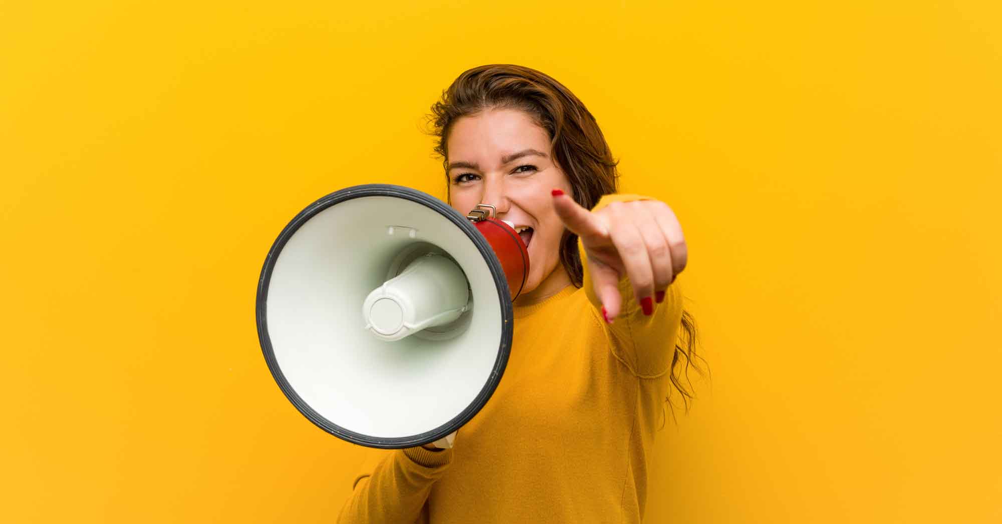 Woman holding a bullhorn with a yellow background yelling about reputation marketing.